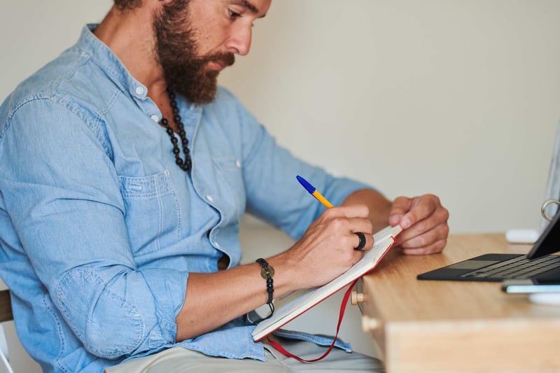 Bearded Man Writing In Journal-how-to-calm-anxiety