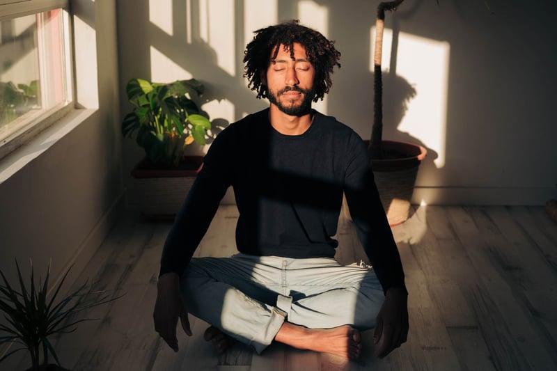 man sitting in silence and meditating peacefully-how-to-calm-anxiety